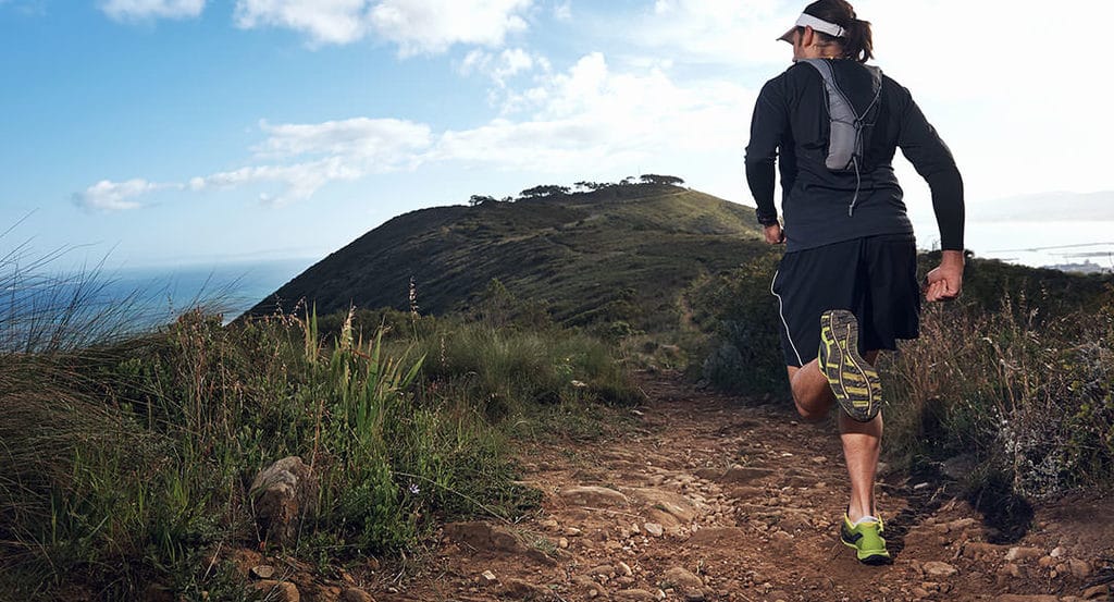 Beginner's Guide: Essential Gear For Trail Running 1 trail runner on mountain trail
