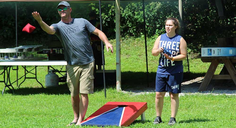 people playing cornhole outside