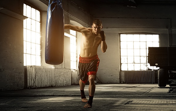 guy boxing heavy bag