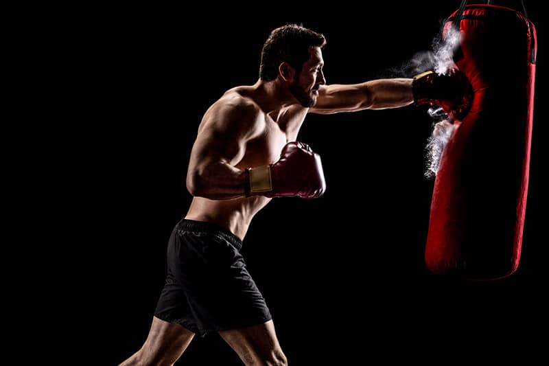 guy hitting heavy bag