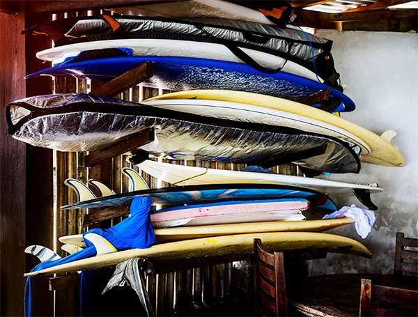 bunch of surfboards on rack