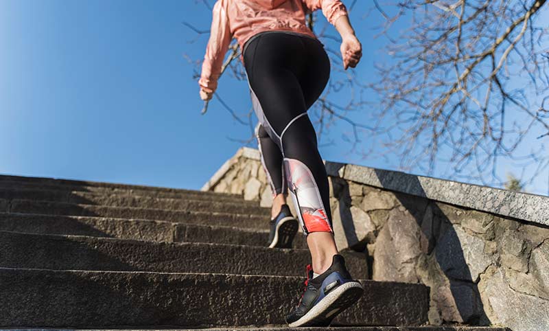 woman climbs stairs for fitness