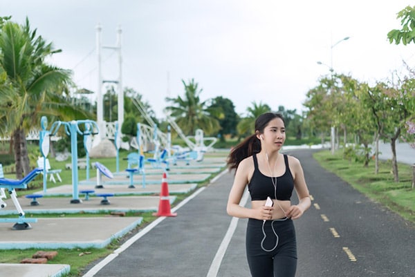 woman jogging with earbuds