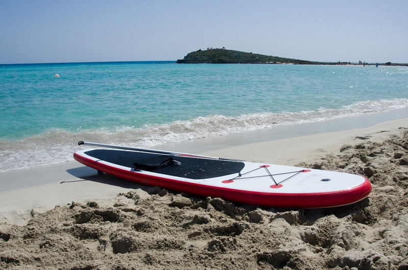 inflatable paddle board on sand