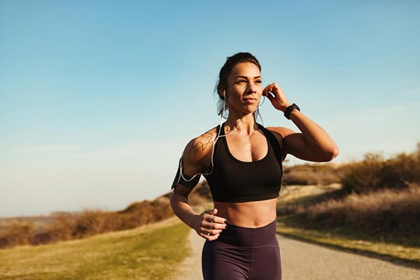 woman running with earbuds