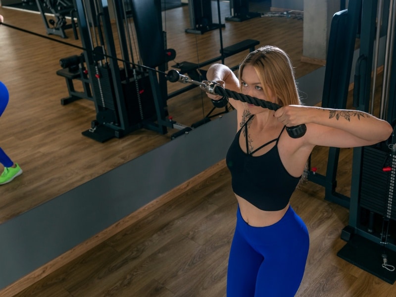 woman doing tricep cable pulldown exercises