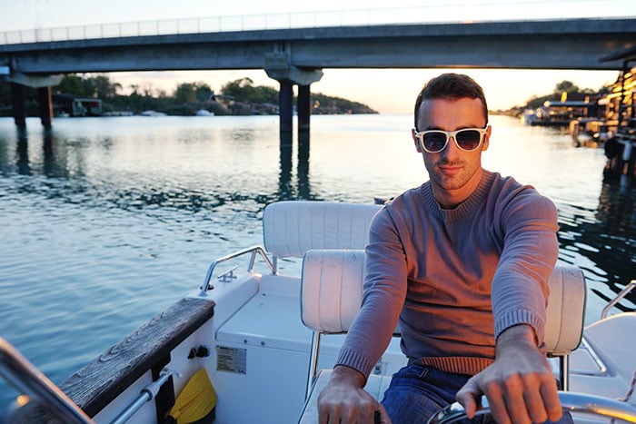 Do You Need A License To Drive A Boat? (Laws For All 50 States) 2 guy in sunglasses driving boat