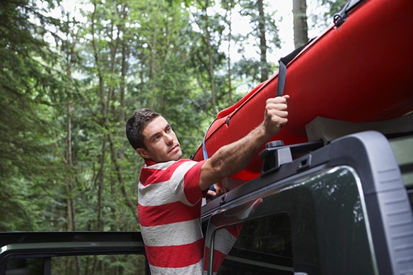 How To Put A Kayak On A Roof Rack By Yourself 1 guy putting kayak on roof rack