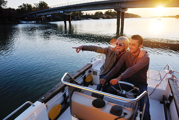 Do You Need A License To Drive A Boat? (Laws For All 50 States) 7 man and woman driving boat in river
