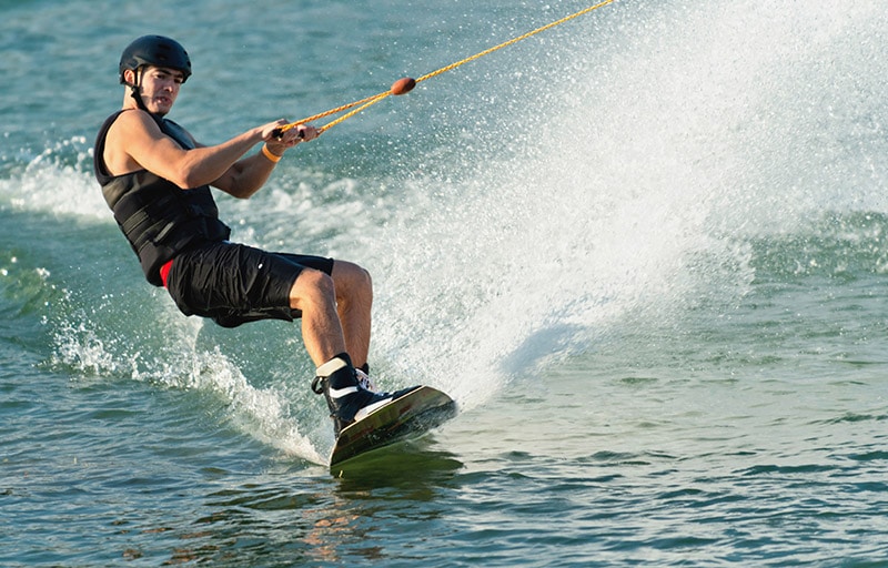 Kneeboarding Vs. Wakeboarding: What's The Difference? 2 man riding wakeboard