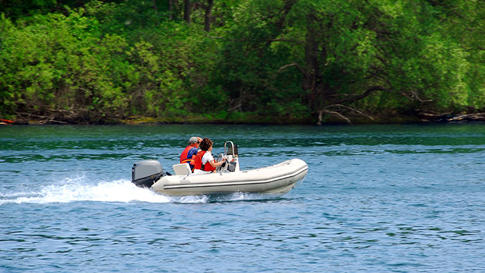 Do You Need A License To Drive A Boat? (Laws For All 50 States) 3 people on inflatable boat