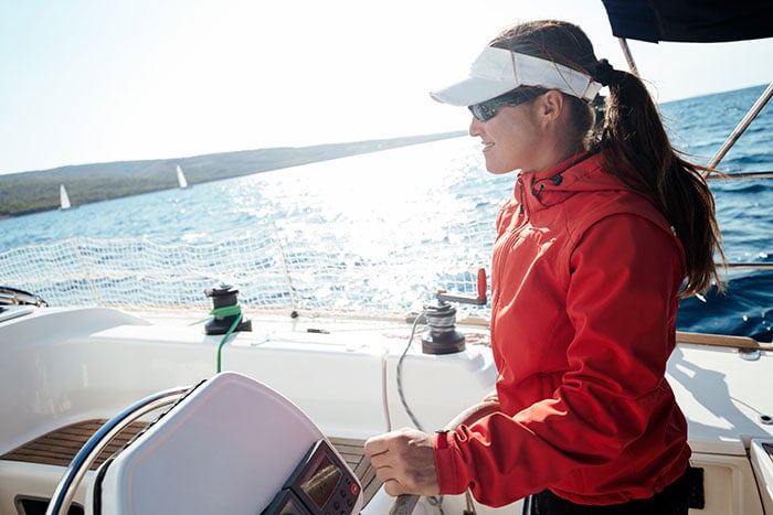 Do You Need A License To Drive A Boat? (Laws For All 50 States) 8 woman driving sailboat