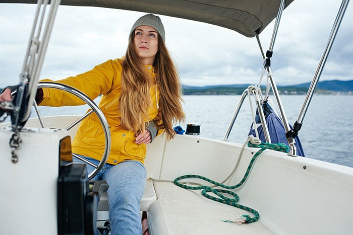 Do You Need A License To Drive A Boat? (Laws For All 50 States) 1 woman driving yacht