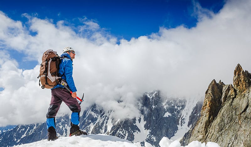 What Is Mountaineering? And How To Get Started 1 mountaineer on mountain top