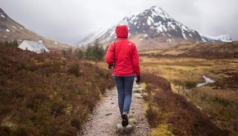 Break In Your Hiking Boots The Right Way With These Tips 1 woman hiking in winter