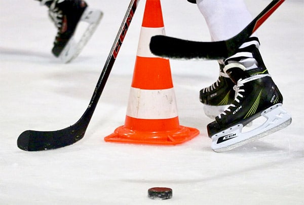 How To Lace Hockey Skates The Right Way 3 hockey skates on ice with puck