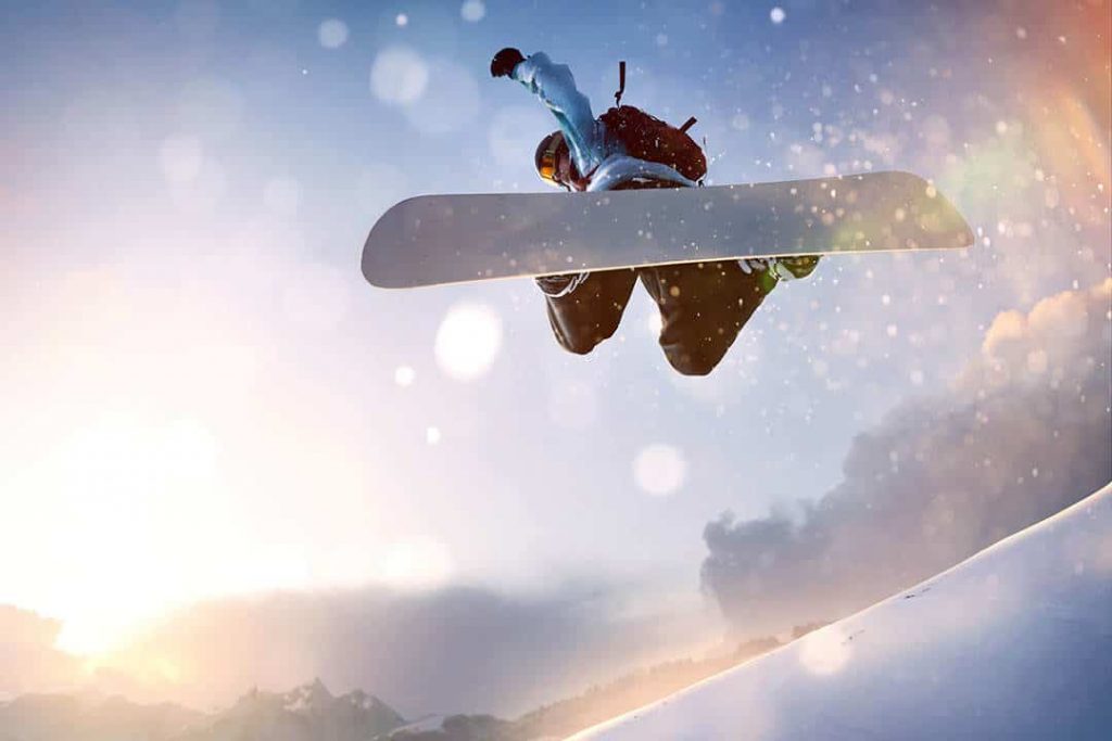 Choosing A Good Snowboard For Beginner Shredding (2022) 1 snwboarder in air