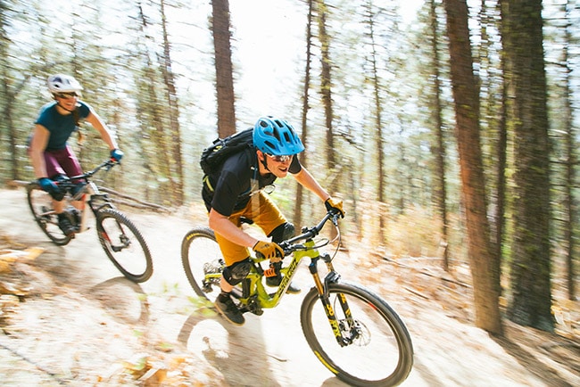 What Is MIPS? Does My Bike Helmet Need It? 2 men on mountain bike trail