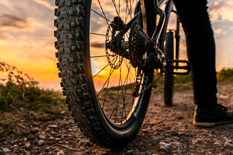 bike wheel and cyclist wearing pants