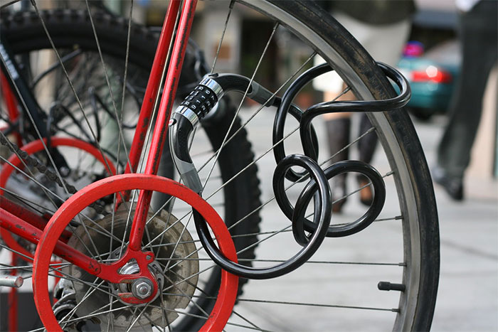 How To Lock Your Bike Without A Bike Rack 6 bike with cable lock through wheel spokes